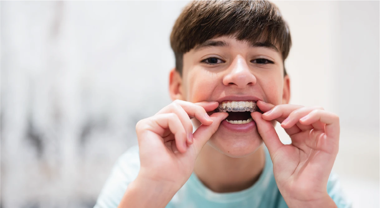 Teen using aligners